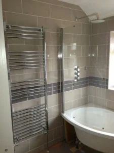 Bathroom fitting with new shower, bath and radiator